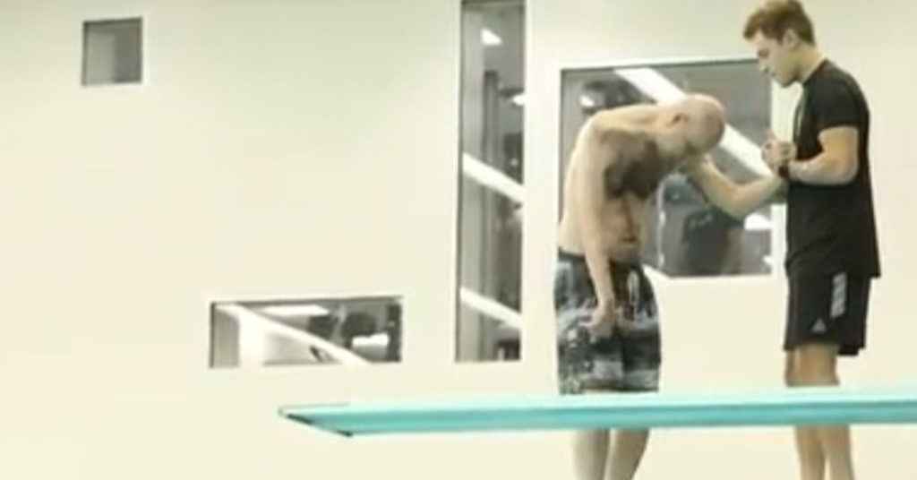 Paralyzed Diver Is Held At The Edge Of Diving Board By His Son, And